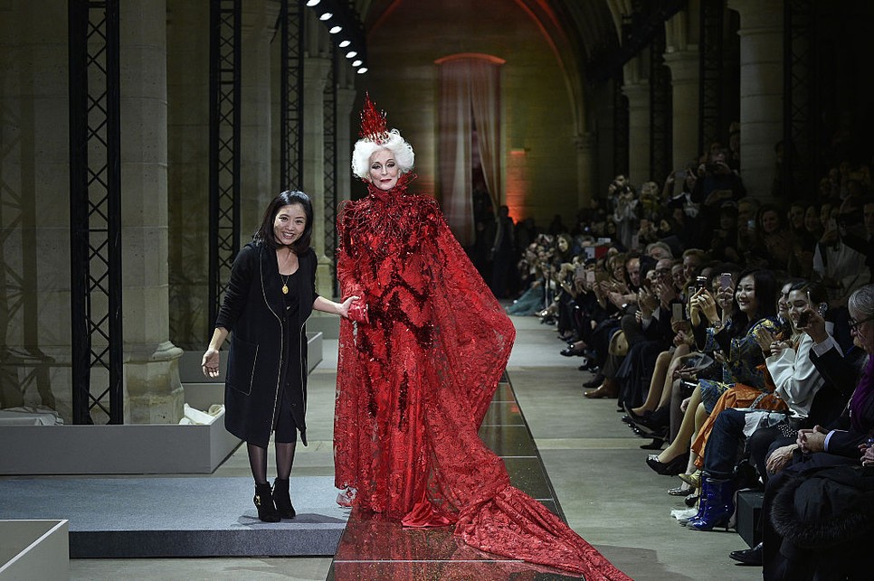 Guo Pei kínai couture-tervező munkái monumentális hímzésekkel és történeti ornamentikákkal gazdag transzformáló ruhaszobrokként jelentek meg.