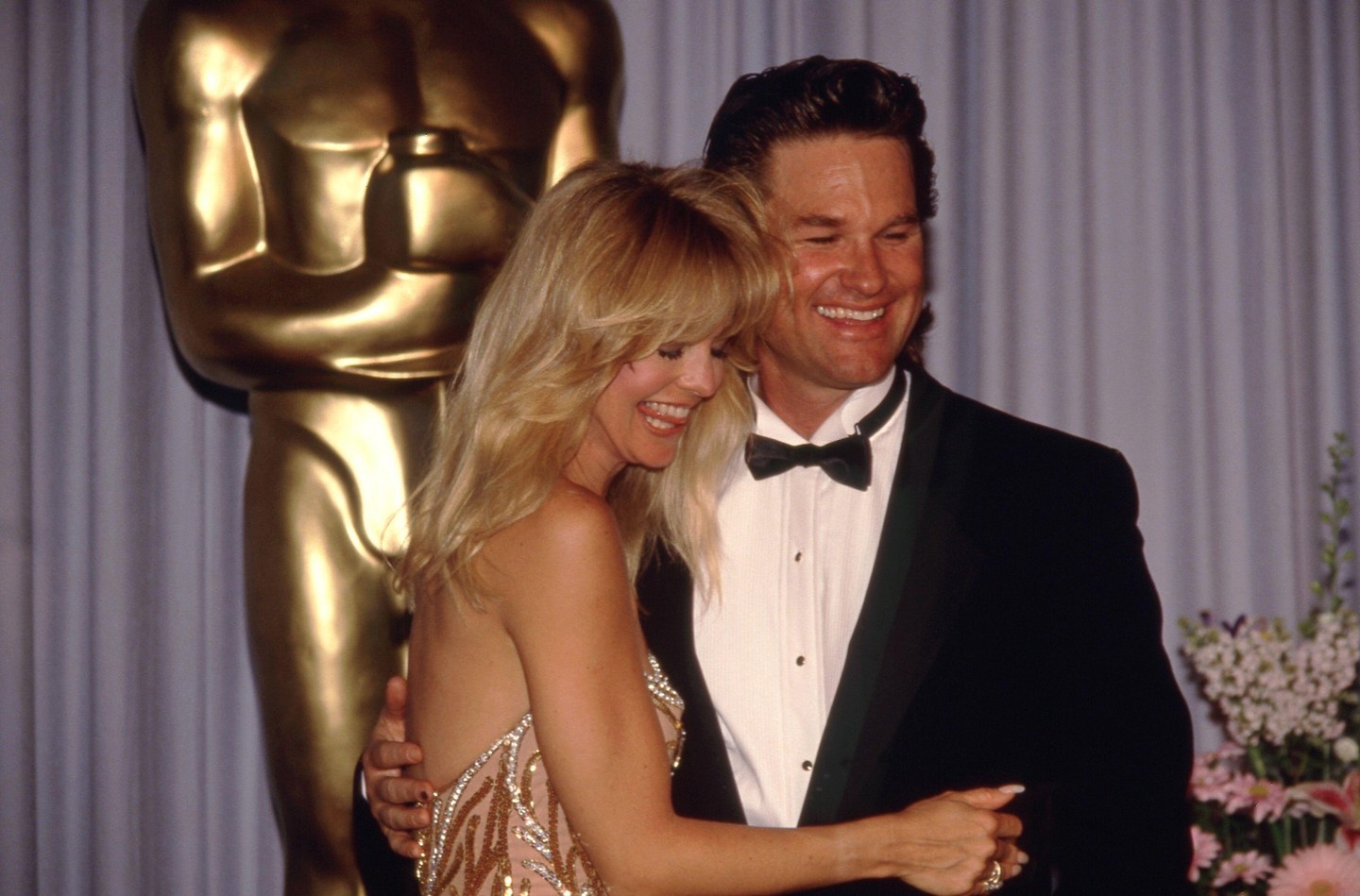 1989-et írunk, az Oscar-gála vörös szőnyegén mindenki a tökéletes pózt keresi, kivéve őket: Goldie Hawn és Kurt Russel ezen a felvételen is azt mutatják, hogy számukra a világ megszűnik létezni, ha egymás közelében vannak. Gyakran faggatták őket akkoriban az esküvőről, de ők már akkor is sziklaszilárdan hittek abban, hogy papír nélkül is erős a kapocs köztük.