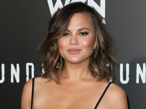 Videó! Chrissy Teigen megpróbálta betuszkolni a melleit a ruhába, nem sikerült