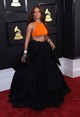 Egyszerűen minden részletét imádjuk Rihanna 2017-es Armani mengjelenésének. A narancsos, strasszokkal díszített crop top izgalmas kontrasztot alkot a fekete organza szoknyával, tökéletes választás volt a Grammy-gálára. 