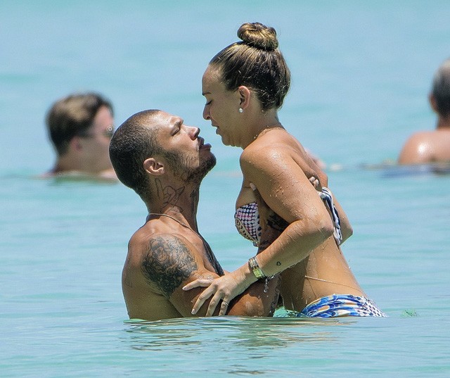 A börtönviselt férfimodell a tengerparton hesszel a milliárdos barátnőjével, míg felesége a válópert fogalmazza