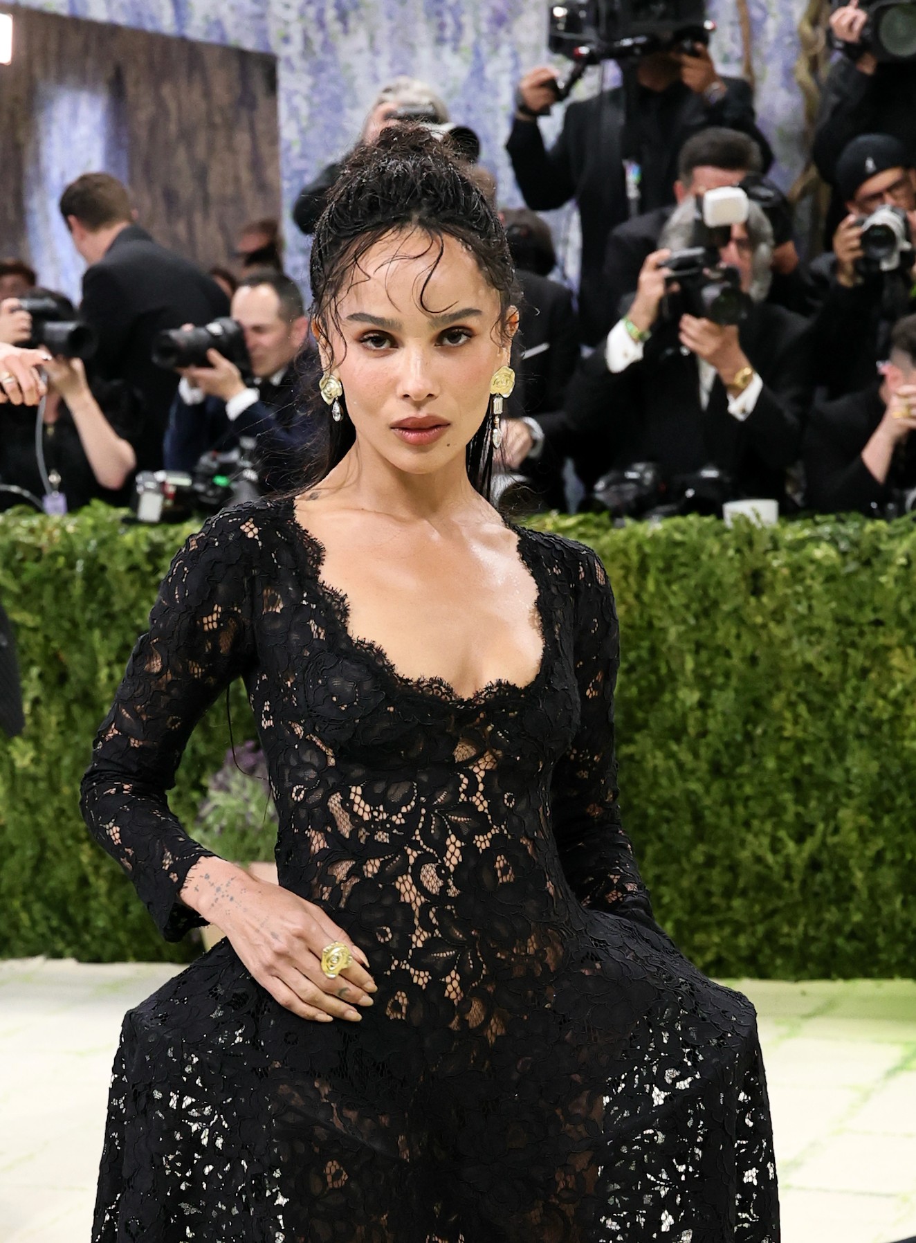 Zoë Kravitz a bevonulás alatt gondosan ügyelt arra, hogy a Harry Styles-tól kapott eljegyzési gyűrűjét még ne fedje fel a nagyközönség előtt. Ugyanakkor Jessica McCormack ékszerei nagyon látványos kiegészítői voltak a megjelenésének.