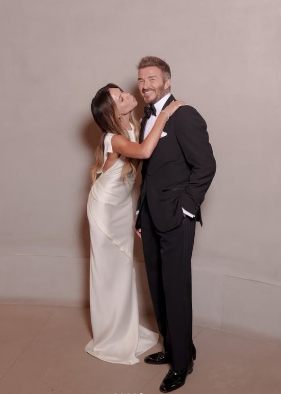 Victoria Beckham egy általa tervezett selyemestélyiben, David Beckham pedig elegáns szmokingban flörtölt a fotósok előtt