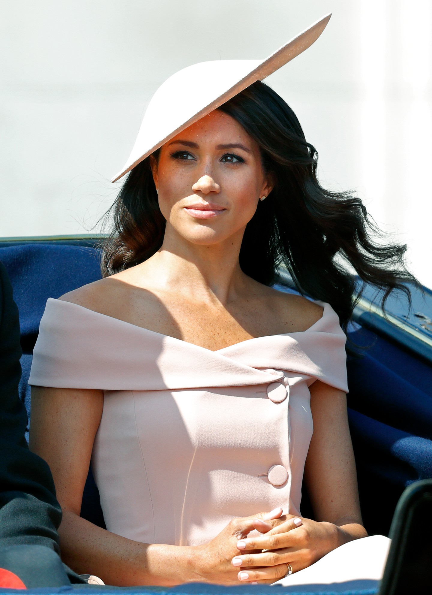 Meghan Markle elegáns Carolina Herrera ejtett vállú ruhában fedte fel vállait, ezt a szabást azonban a királyi család nőtagjai inkább elkerülik, különösen a formális eseményeken