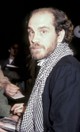 A lezser elegancia mestere (1985): John Malkovich sosem tartozott a tucatsztárok közé, és ezt a stílusával is rendszeresen bizonyította. Az Eleni című politikai dráma Los Angeles-i premierjén, a beverly hills-i Academy Theater előtt kapta lencsevégre a legendás fotós, Ron Galella. A színész a klasszikus eleganciát egy laza, kockás sállal dobta fel, miközben épp autogramot adott a rajongóknak – ez a fajta intellektuális, laza sárm pedig tökéletesen jellemezte őt karrierje legsikeresebb éveinek hajnalán.