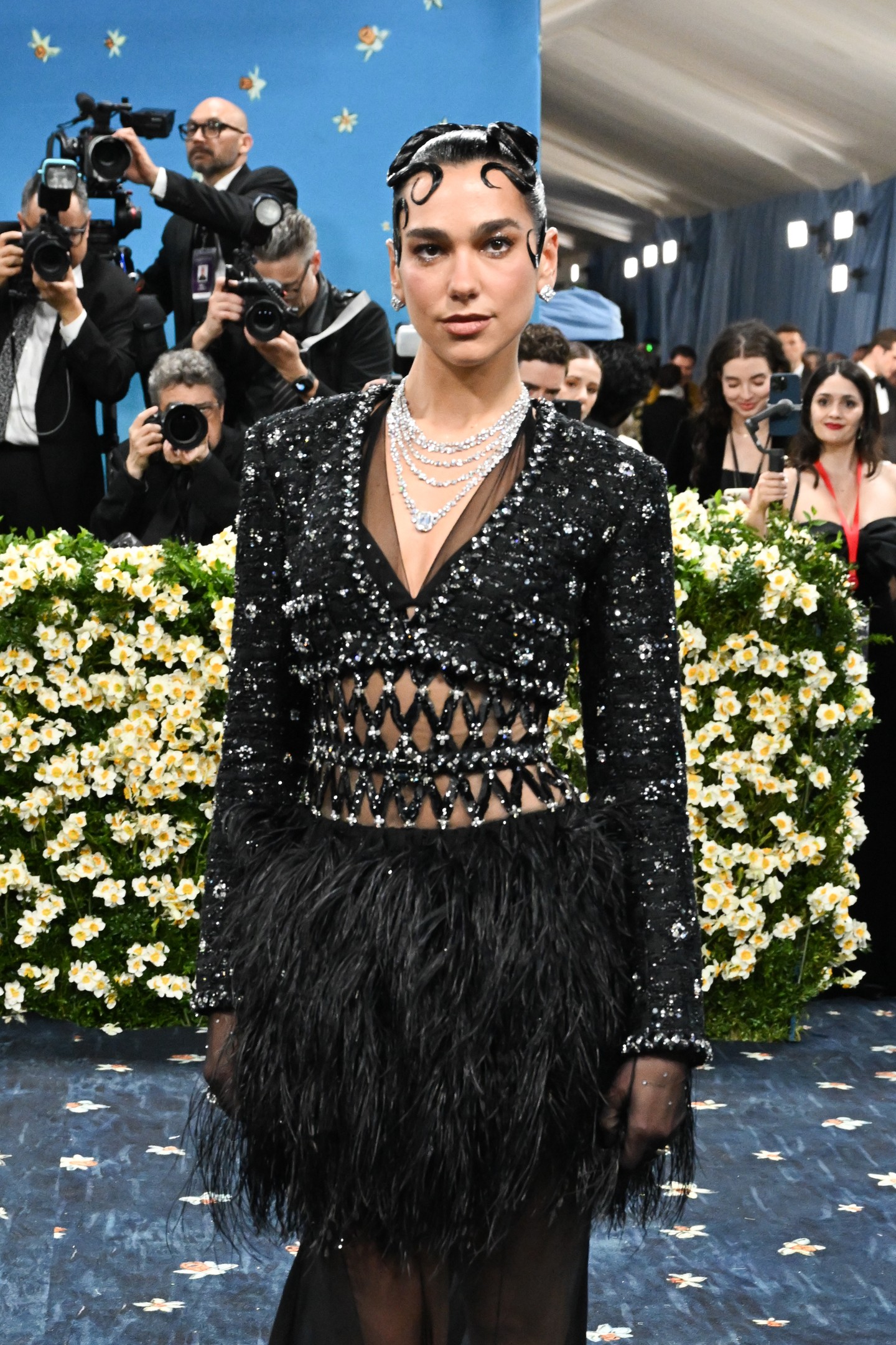 Kiegészítőként áttetsző kesztyűket, fülbevalót és többsoros nyakláncot viselt, amelyek a CHANEL High Jewelry kollekciójából származnak.