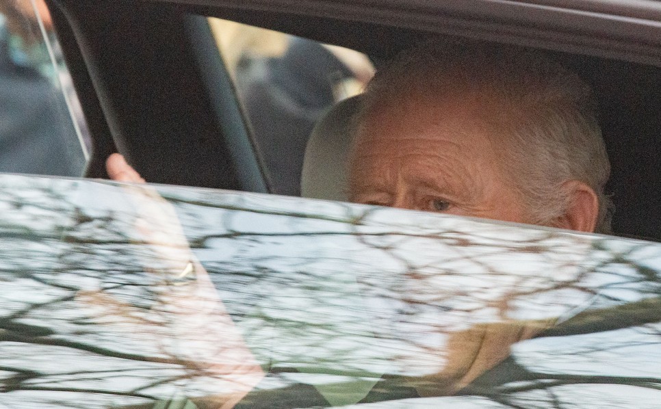 Károly király integet alattvalóinak az elsötétített Audiból